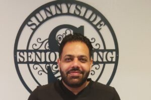 Med Tech Gurpreet Singh smiling at Sunnyside Senior Living, recognized for his dedication to residents